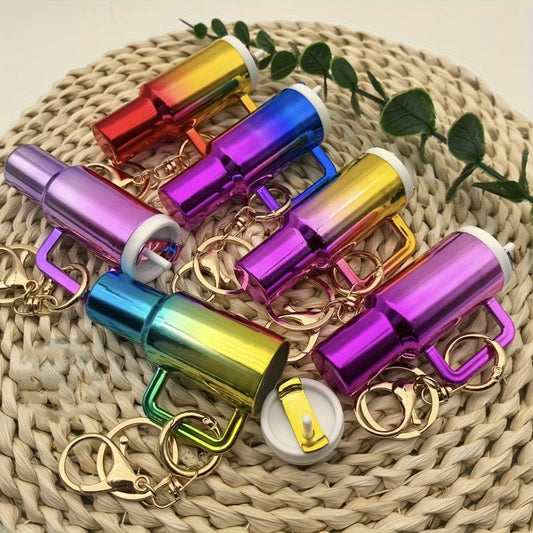 Colorful keychain items with metallic finishes on a woven surface.